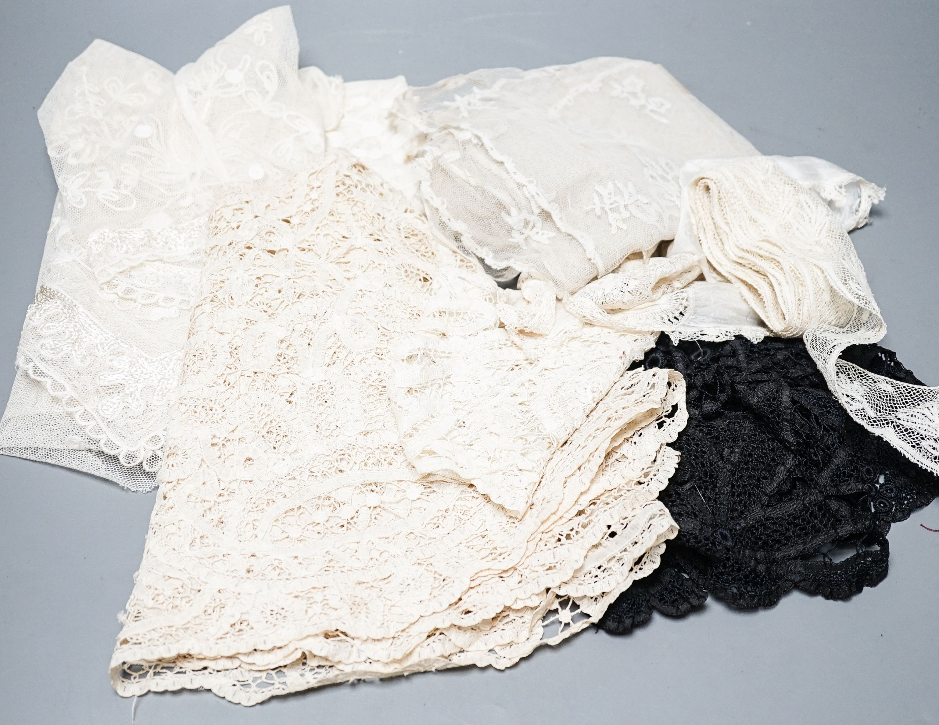 A large tape lace 'Bertha', various hand made laces, lengths of needle run laces, a skirt panel etc.